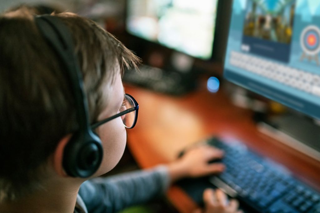 Child with accessibility issues playing Archery Spelling activity